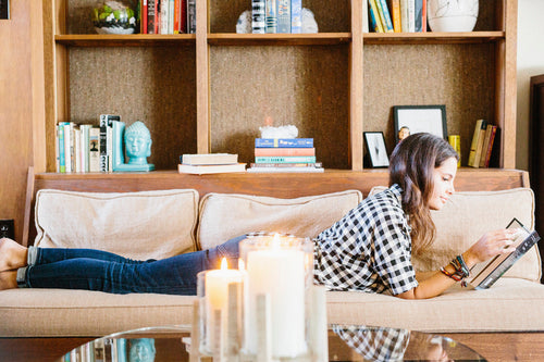 Woman-with-long-brown-hair-lying-on-a-sofa